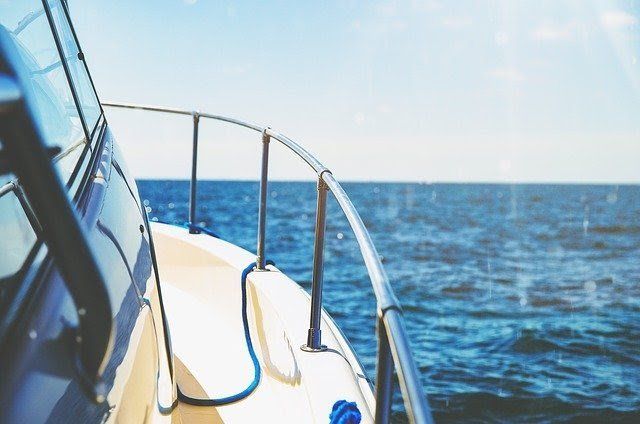 A boat is floating on top of a large body of water.