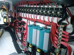The inside of a boat with a lot of wires and electrical equipment.