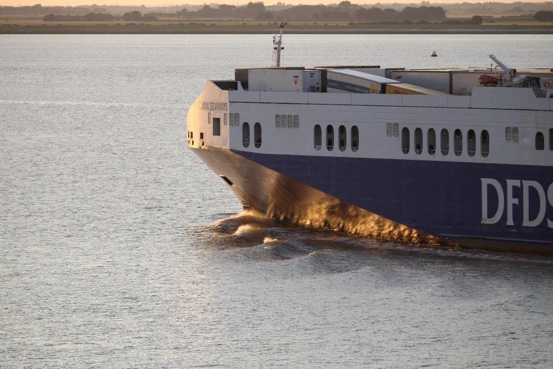 A dfds ship is floating on top of a body of water