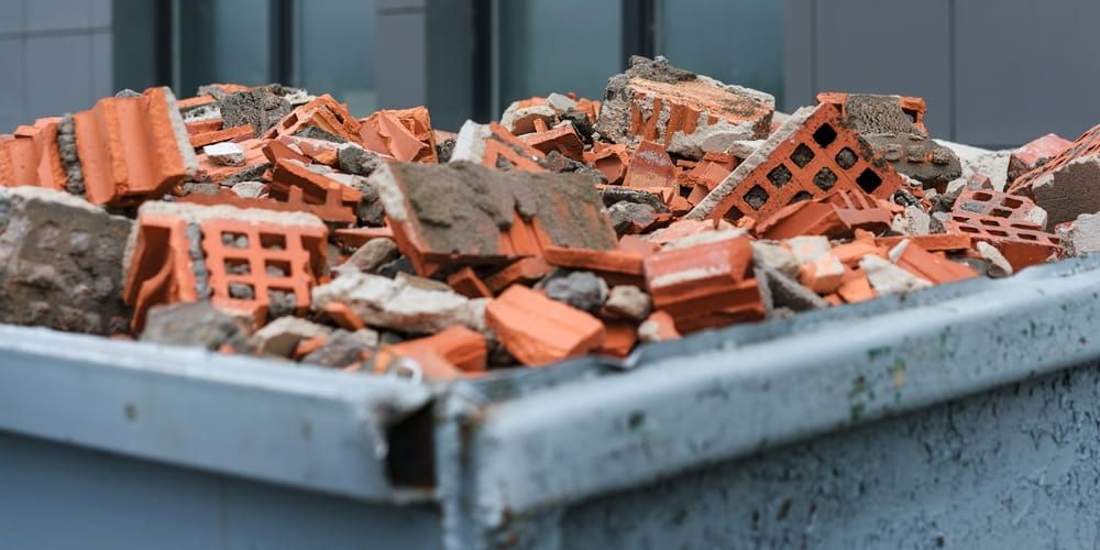 A Dumpster Filled with Bricks and Rocks — Greenline Recycling in Yatala, QLD