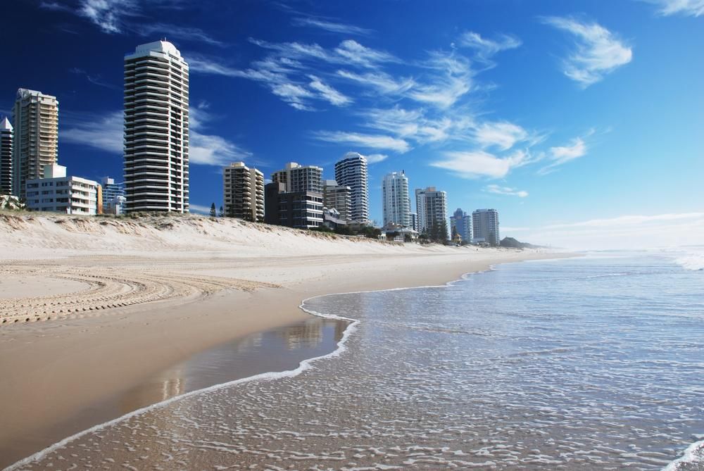 A Beach with Tall Buildings in The Background and A City in The Distance — Greenline Recycling in Redland Bay, QLD