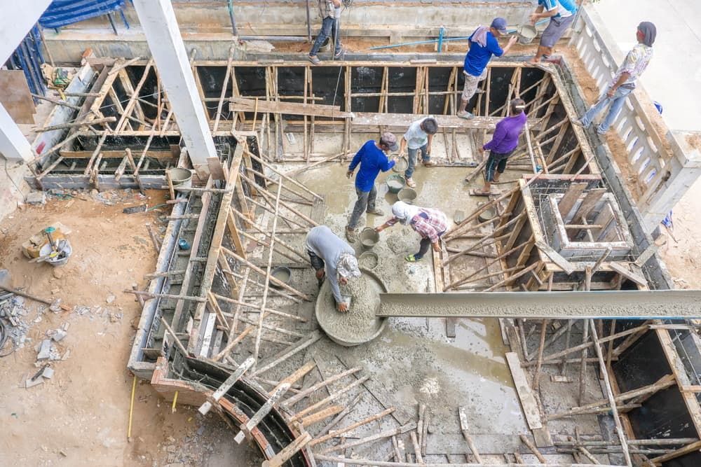 A Group of Construction Workers Are Working on The Foundation of A Building — Greenline Recycling in Ormeau, QLD