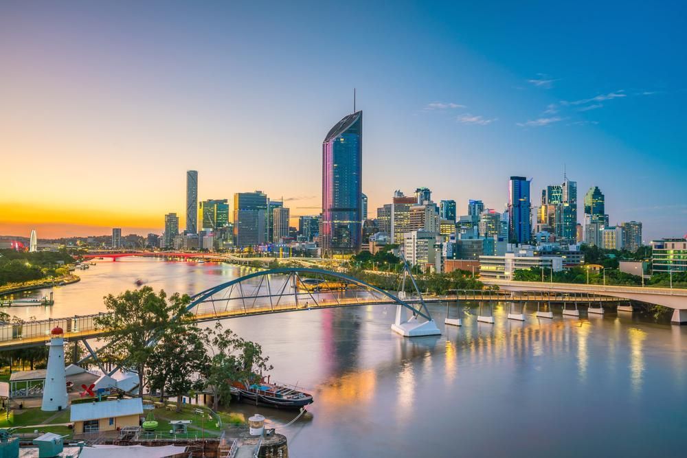 An Aerial View of A City Skyline Over a River at Sunset — Barry's Recycling in Brisbane, QLD