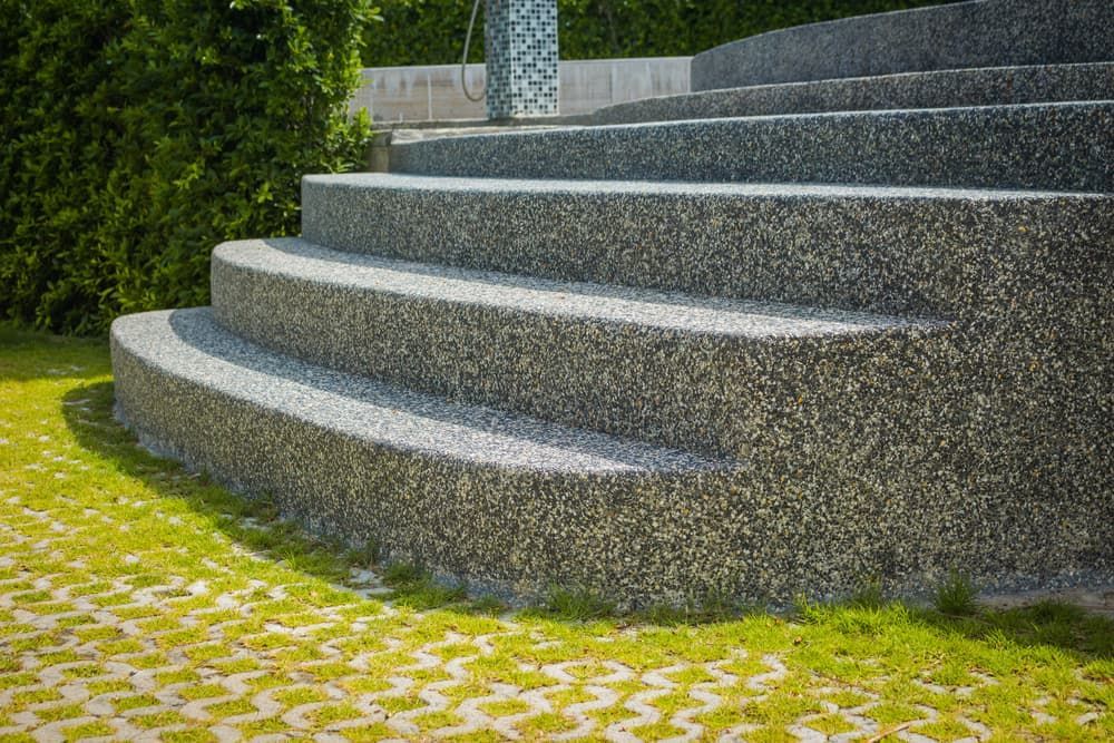 A Set of Concrete Stairs Leading up To a Grassy Area — Greenline Recycling in Yatala, QLD