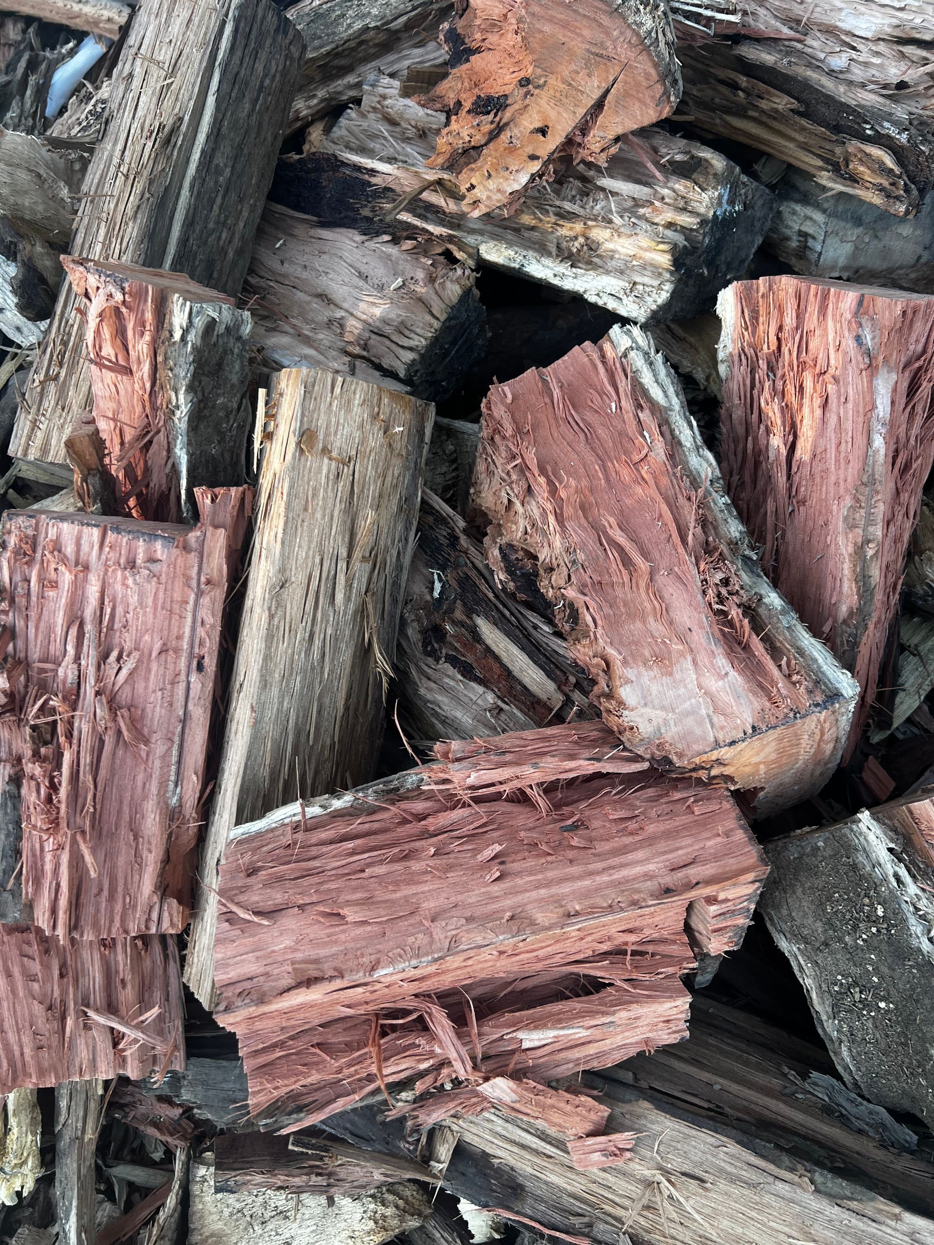 A Pile of Bricks Is Sitting on The Ground in Front of A Garden — Greenline Recycling in Redland Bay, QLD