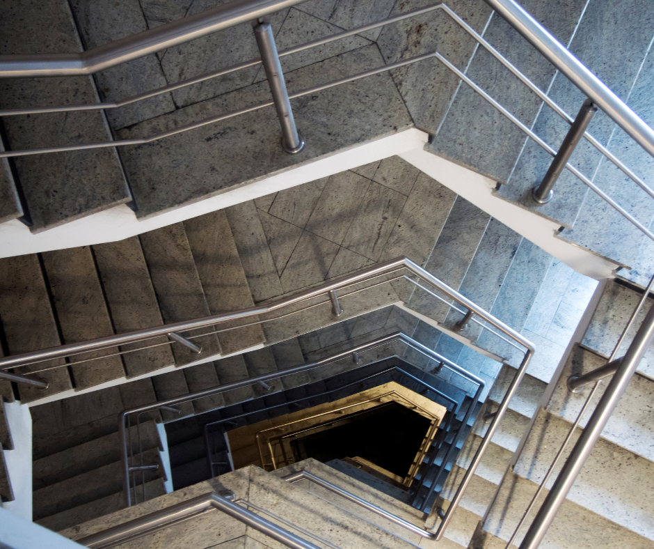 Looking down a set of stairs with a metal railing