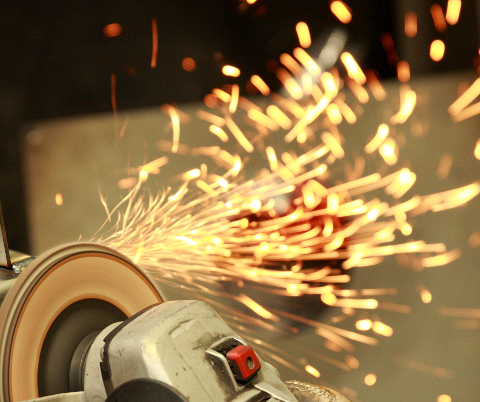 A close up of a grinder with sparks coming out of it