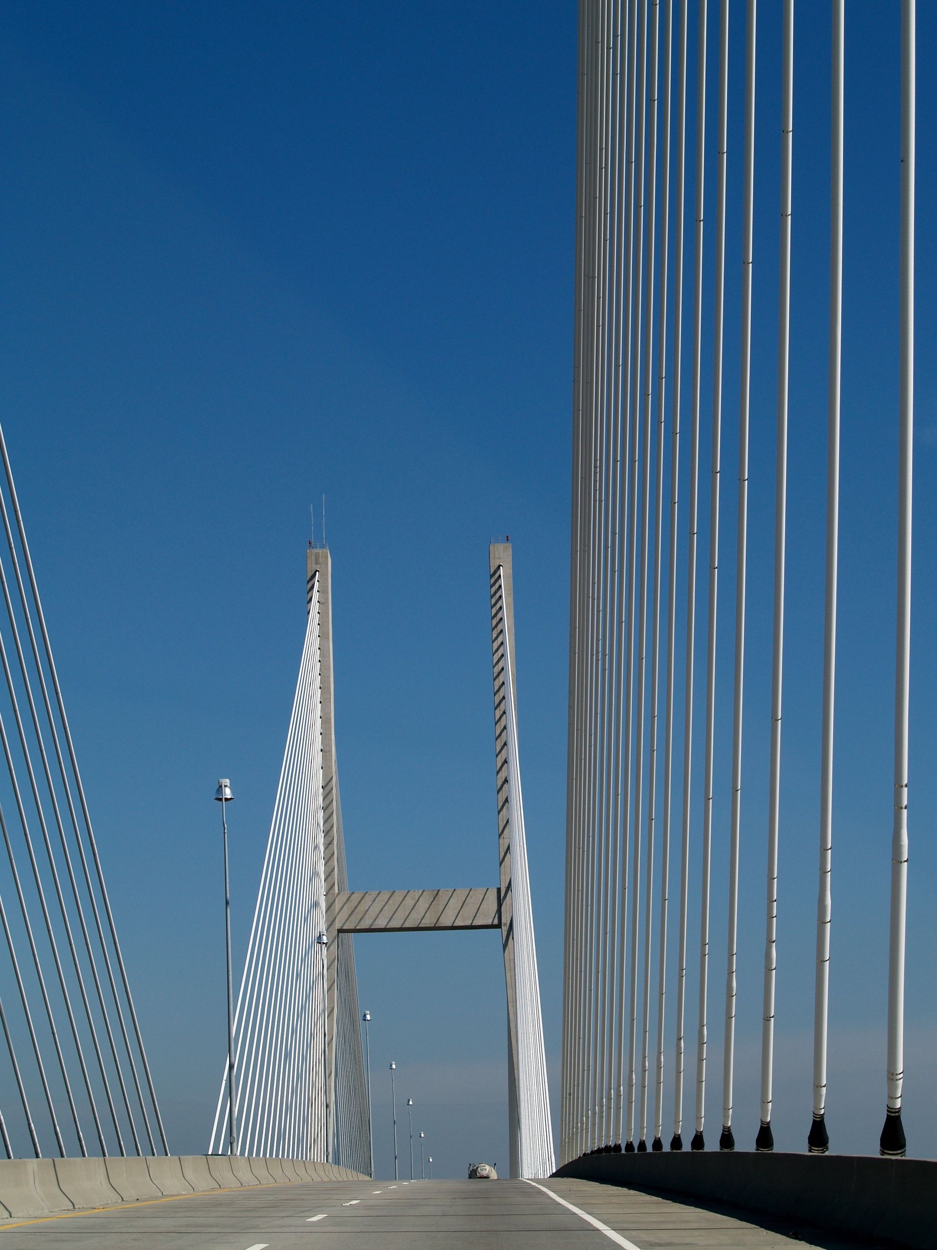 Cable-stayed bridge towers and cables against a clear blue sky