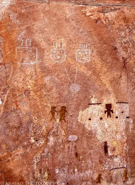 A group of people are walking through a cave.