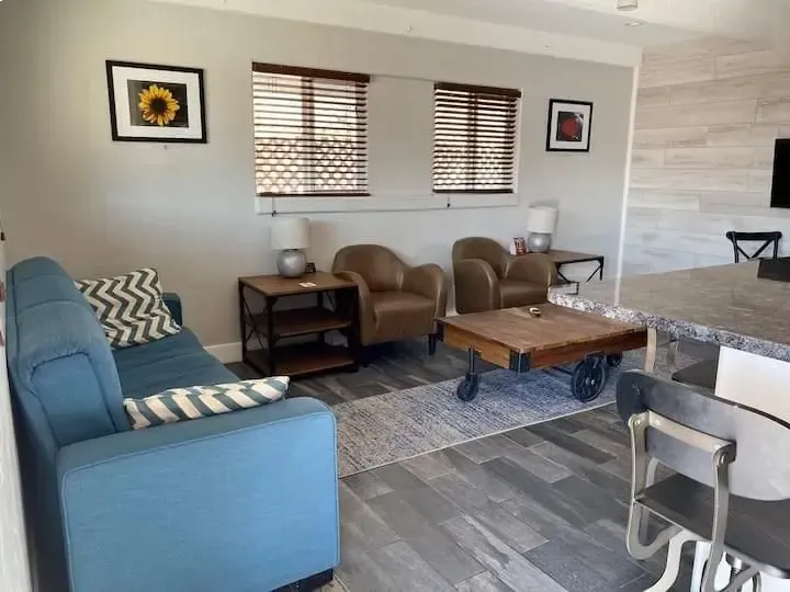 A living room with a blue couch and a coffee table
