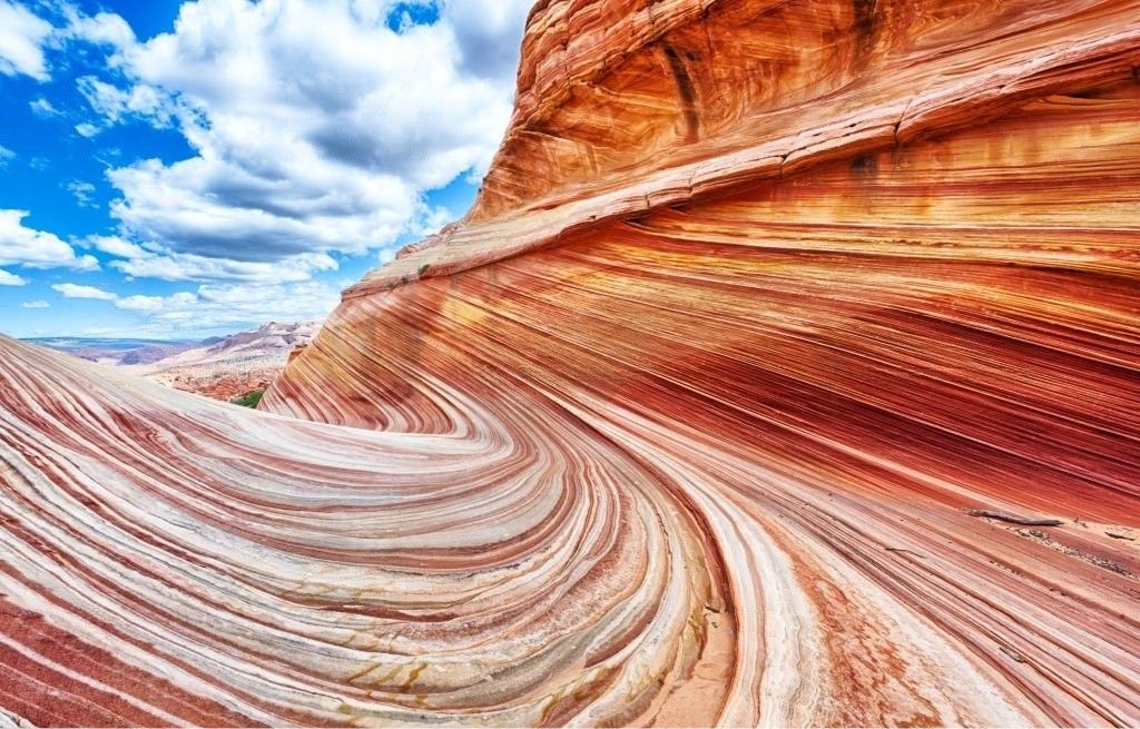 A close up of a rock formation in the desert with a blue sky in the background.