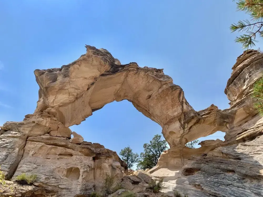 A large rock formation with a blue sky in the background.