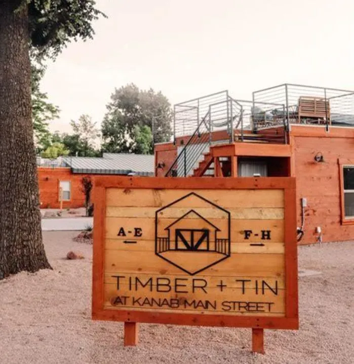 A wooden sign that says timber + tin at kanabman street