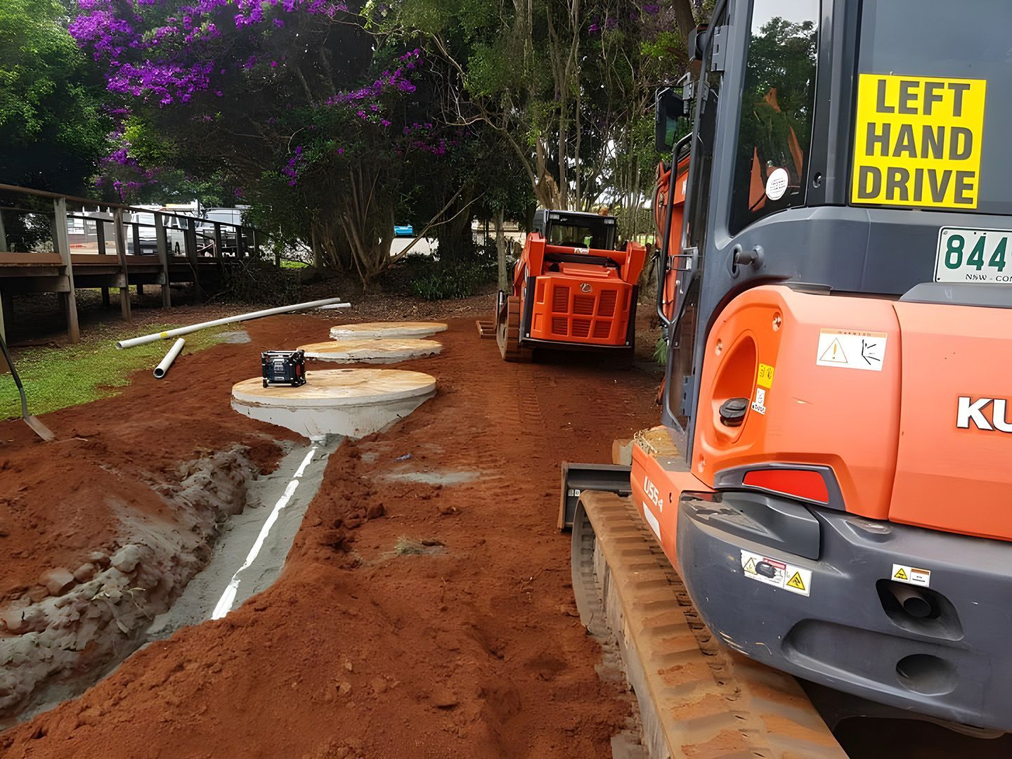 Road Construction With Orange Excavators Digging