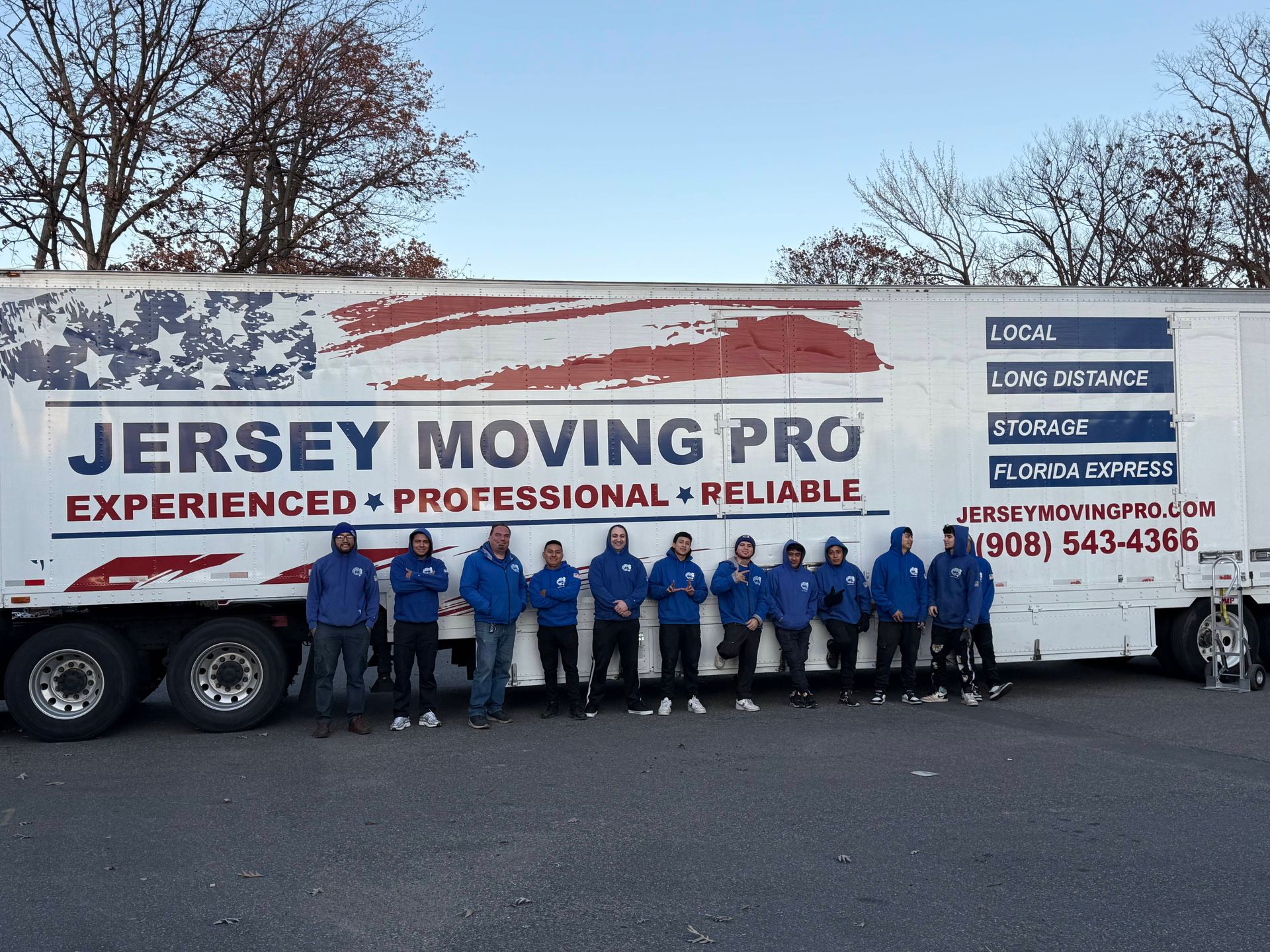 Jersey Moving Pro truck with a team of movers posing in front of it.