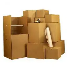 Stacked cardboard moving boxes in a warehouse-like arrangement, with one open box and a rolled poster leaning against it