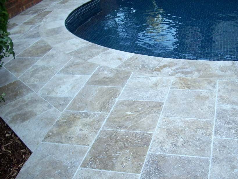 Pool With Tan Stone Tiles Surrounding It — Hunter Valley Bricks & Pavers in Scone, NSW