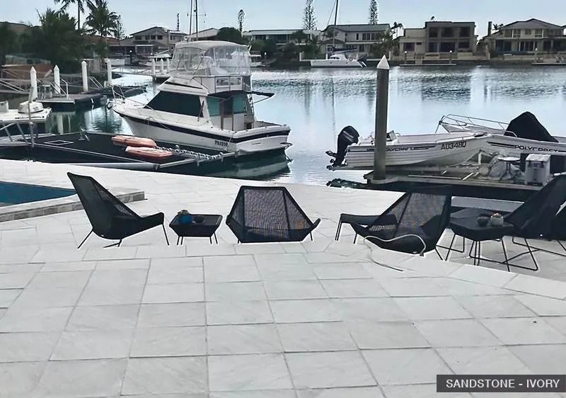 Patio Furniture Overlooking a Canal With Boats and Houses — Hunter Valley Bricks & Pavers in Scone, NSW
