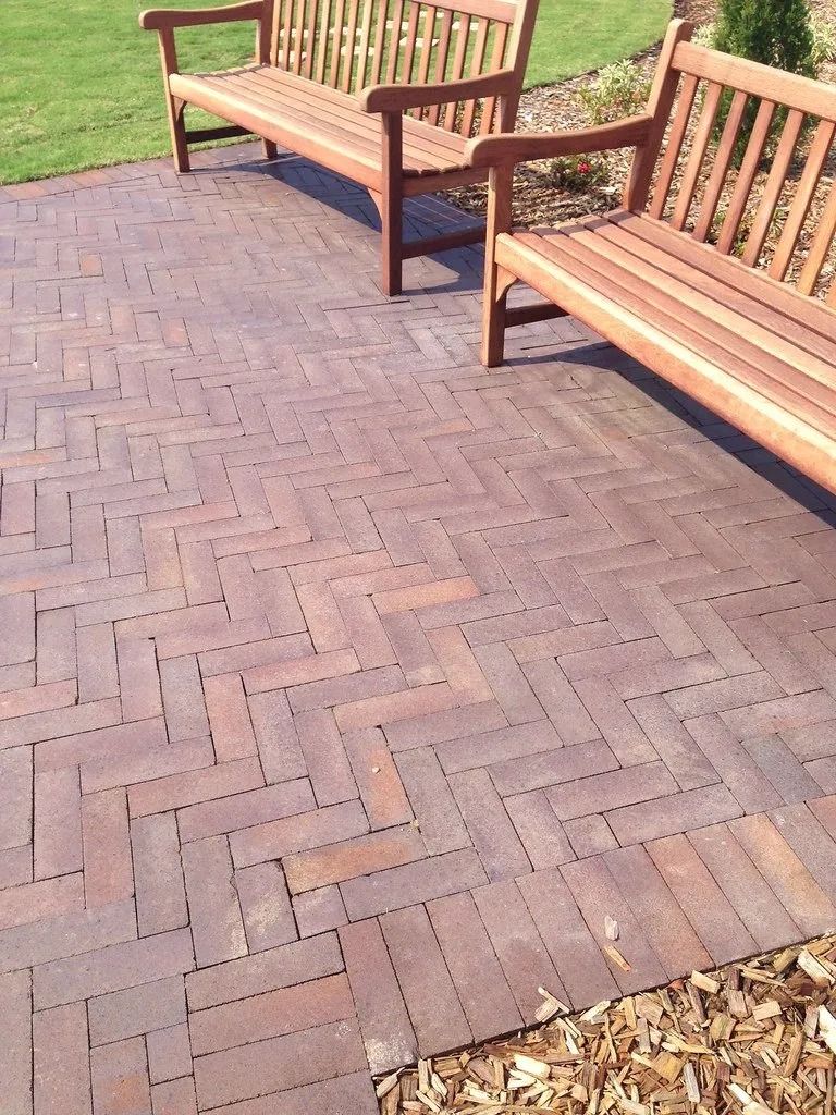 Two Wooden Benches on a Brick Patio With a Herringbone Pattern — Hunter Valley Bricks & Pavers in Scone, NSW