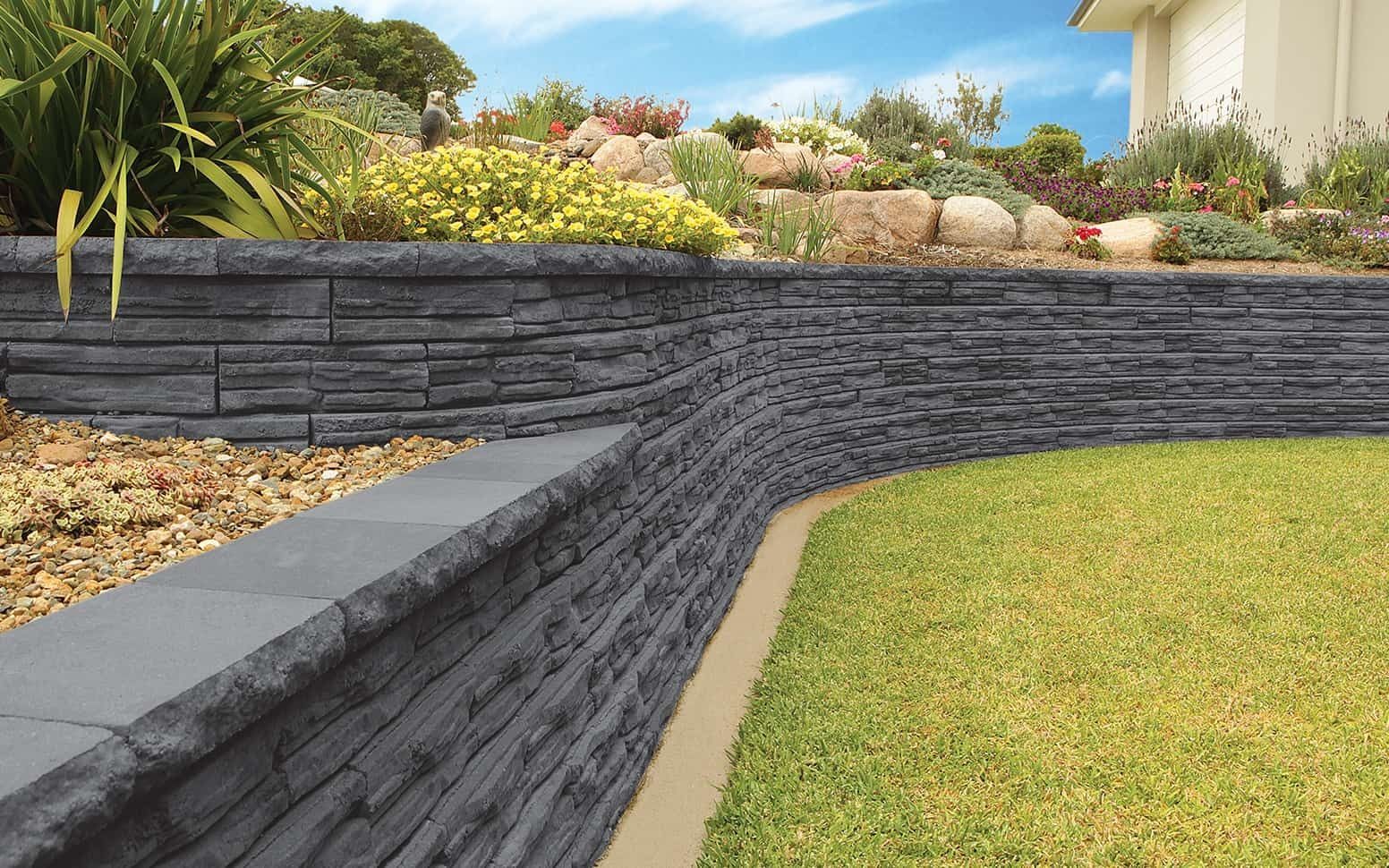 Gray Retaining Walls Separate a Landscaped Garden From a Lawn — Hunter Valley Bricks & Pavers in Scone, NSW