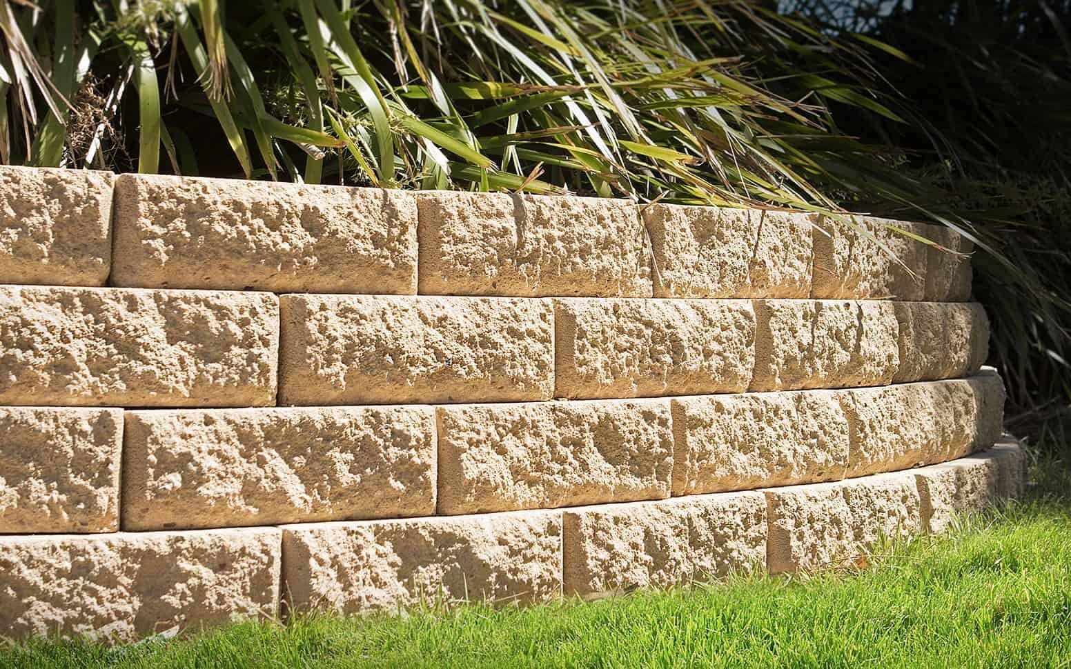 Tan, Curved Retaining Wall Made of Textured Blocks — Hunter Valley Bricks & Pavers in Scone, NSW