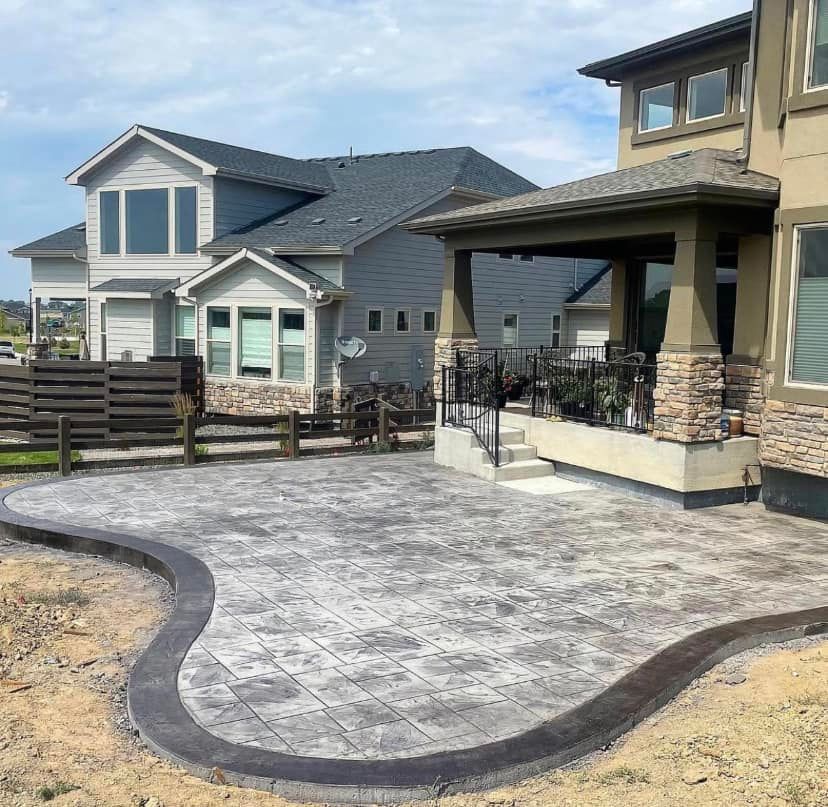 A large house with a curved patio in front of it.