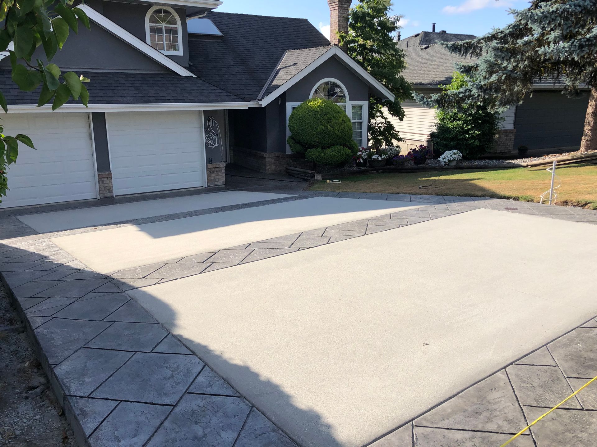A large house with a concrete driveway in front of it.