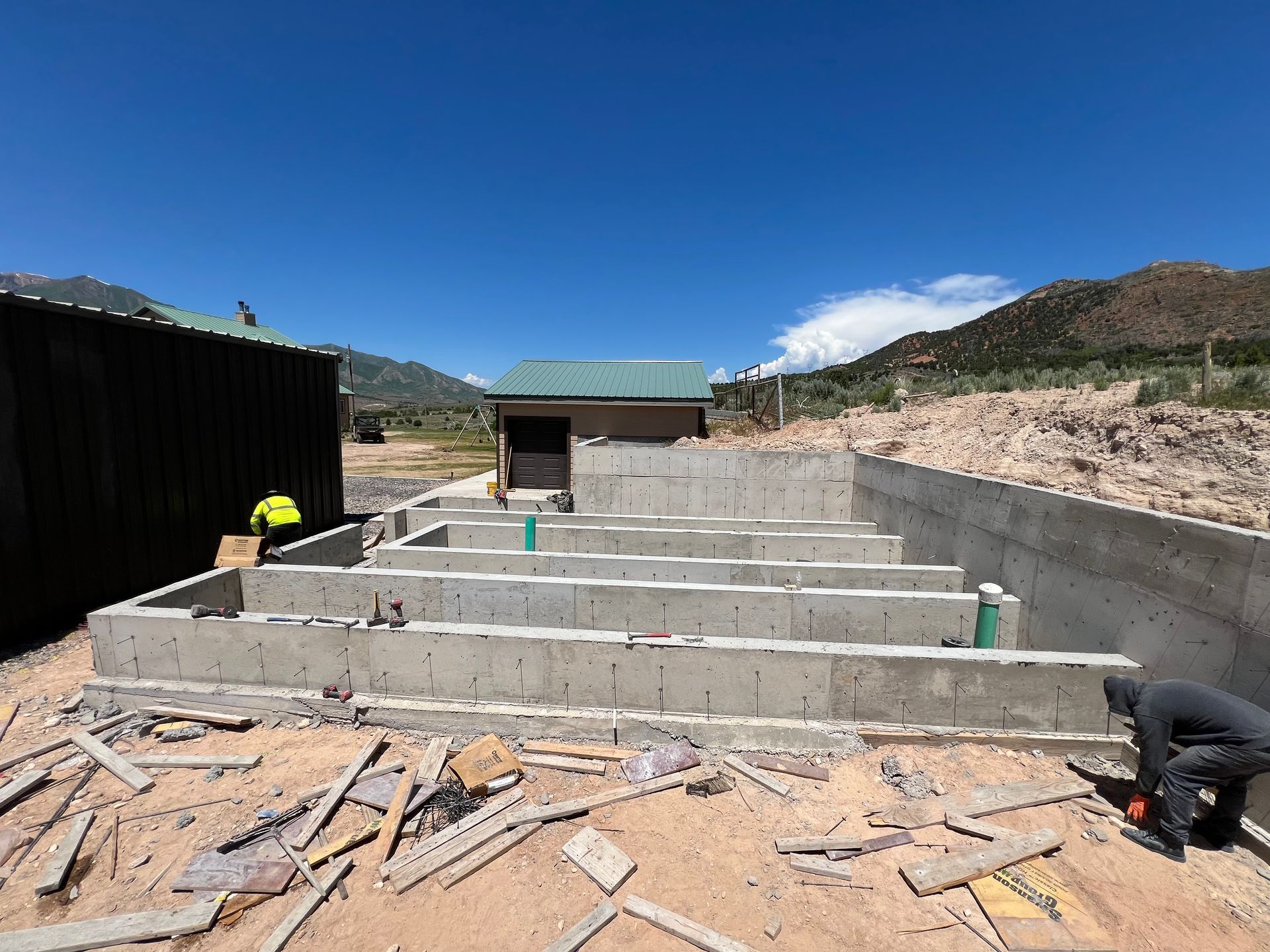 A concrete driveway is being built on a construction site.