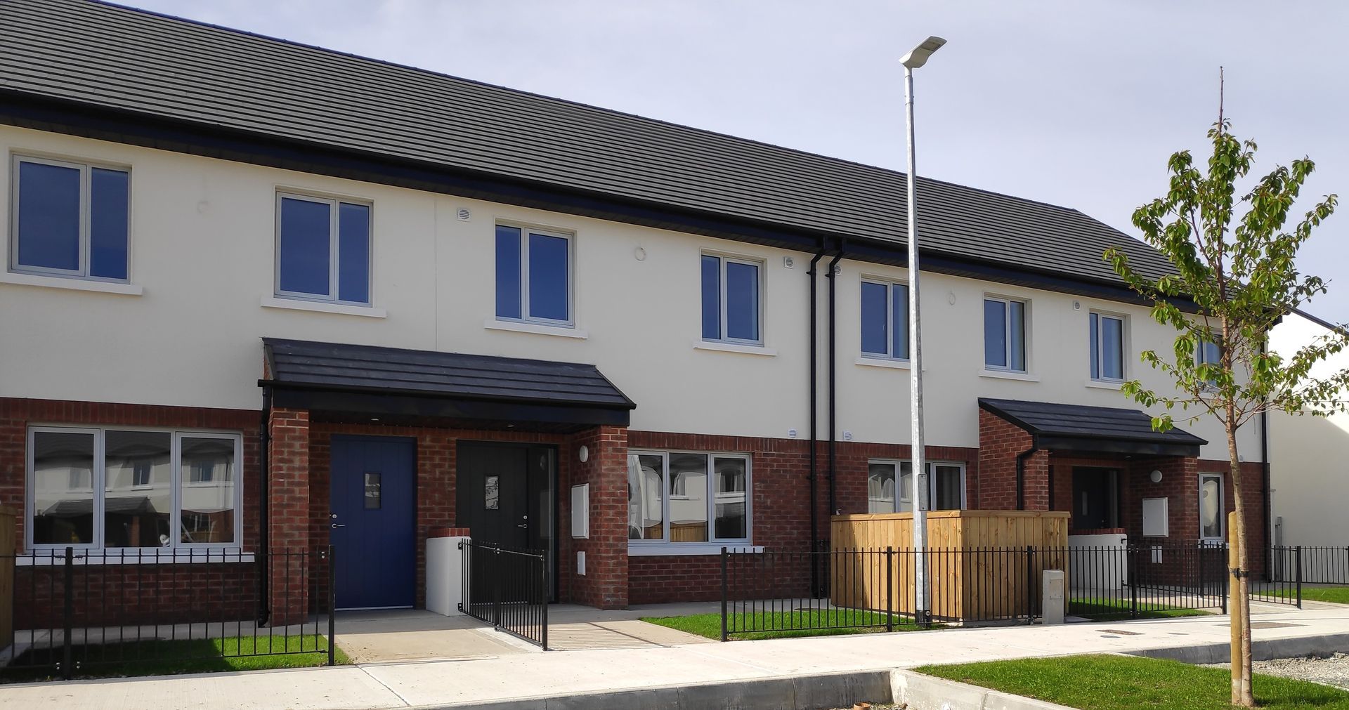 A row of houses with blue doors and windows