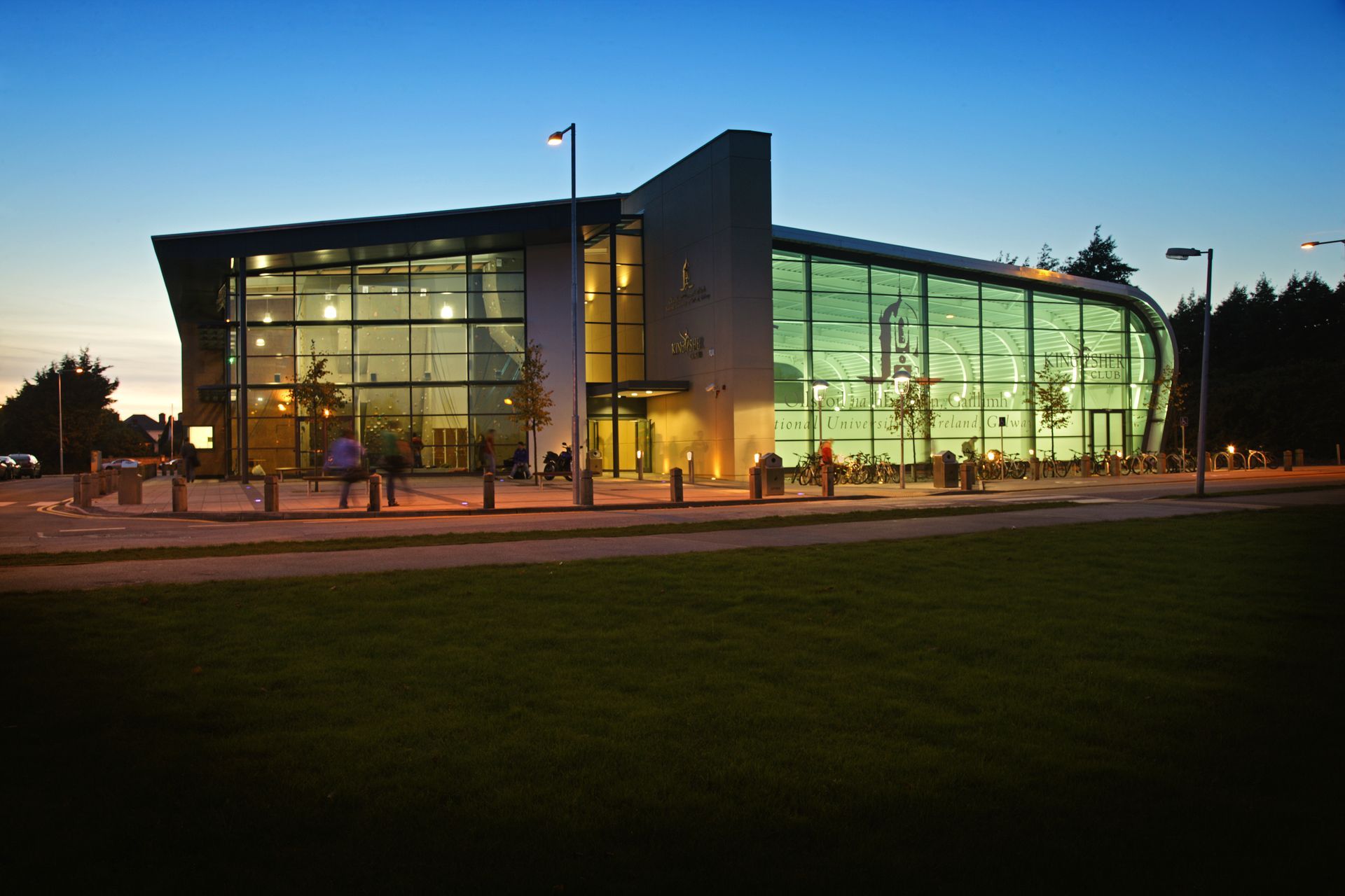 A large building with a lot of windows is lit up at night
