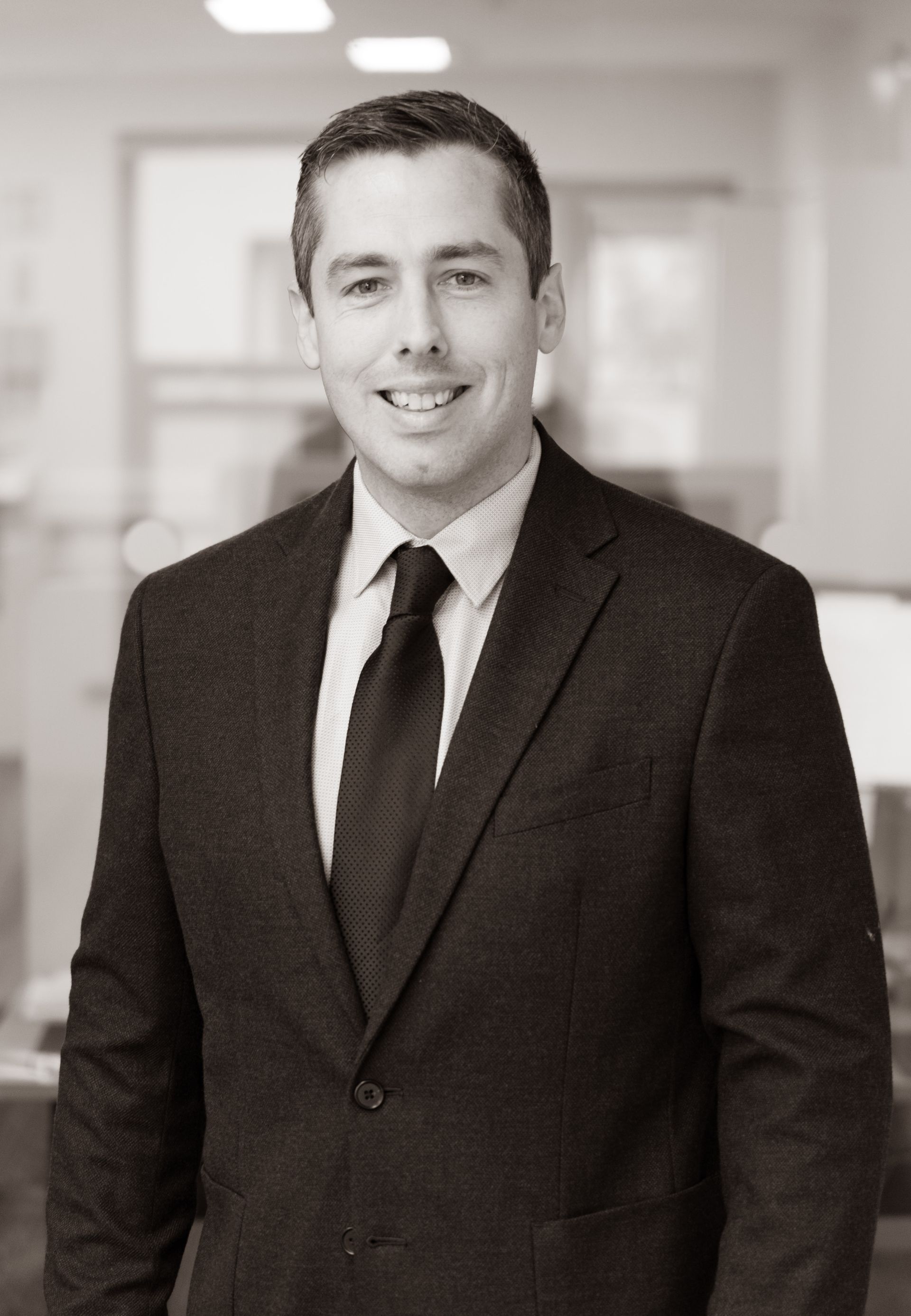 A man with a beard is wearing a suit and tie.