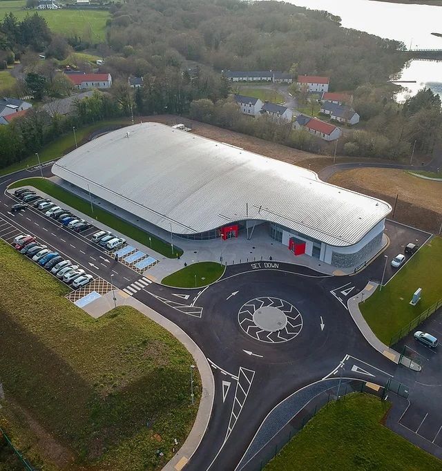 An aerial view of a large building with a roundabout in front of it