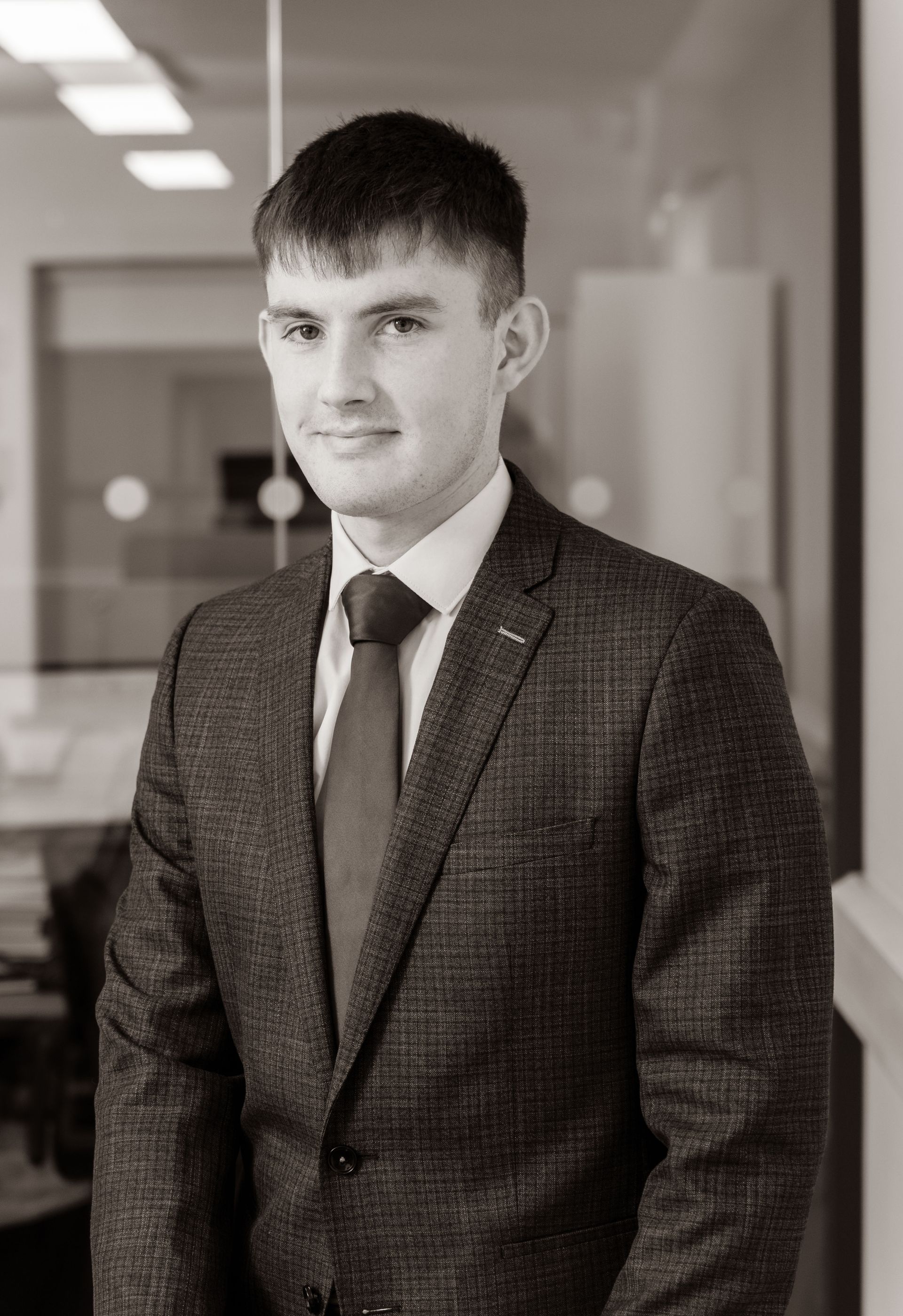 A man with a beard is wearing a suit and tie.