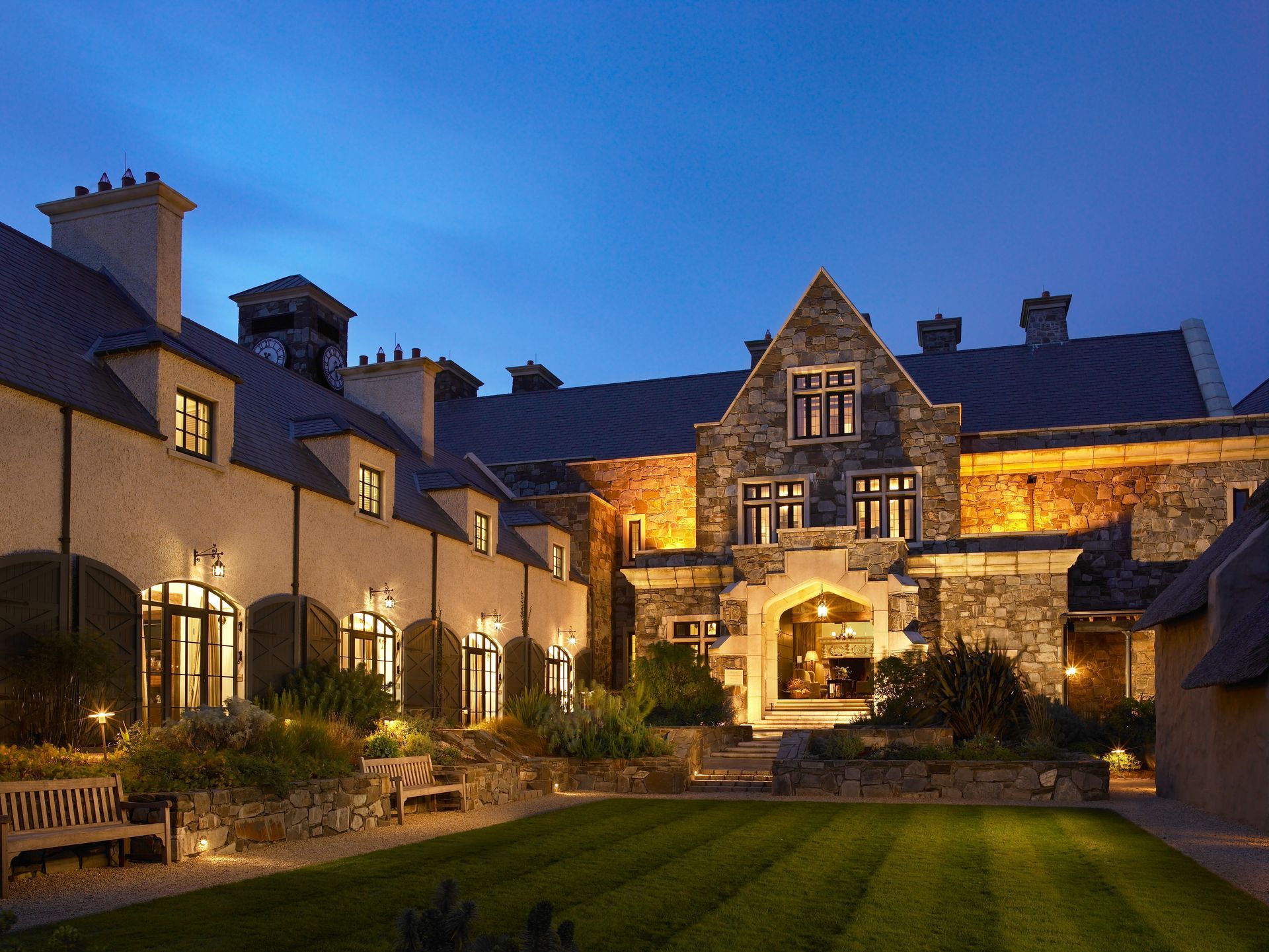 A large stone building with a lawn in front of it