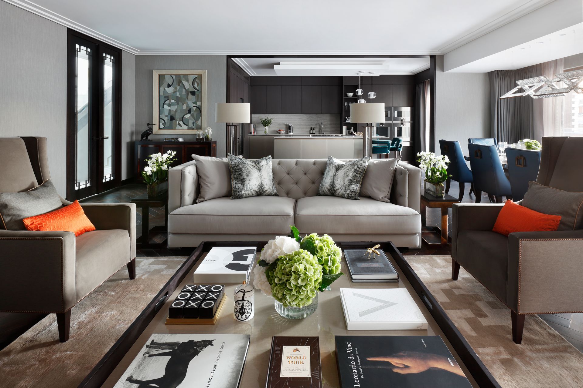 A living room with a couch , chairs and a coffee table