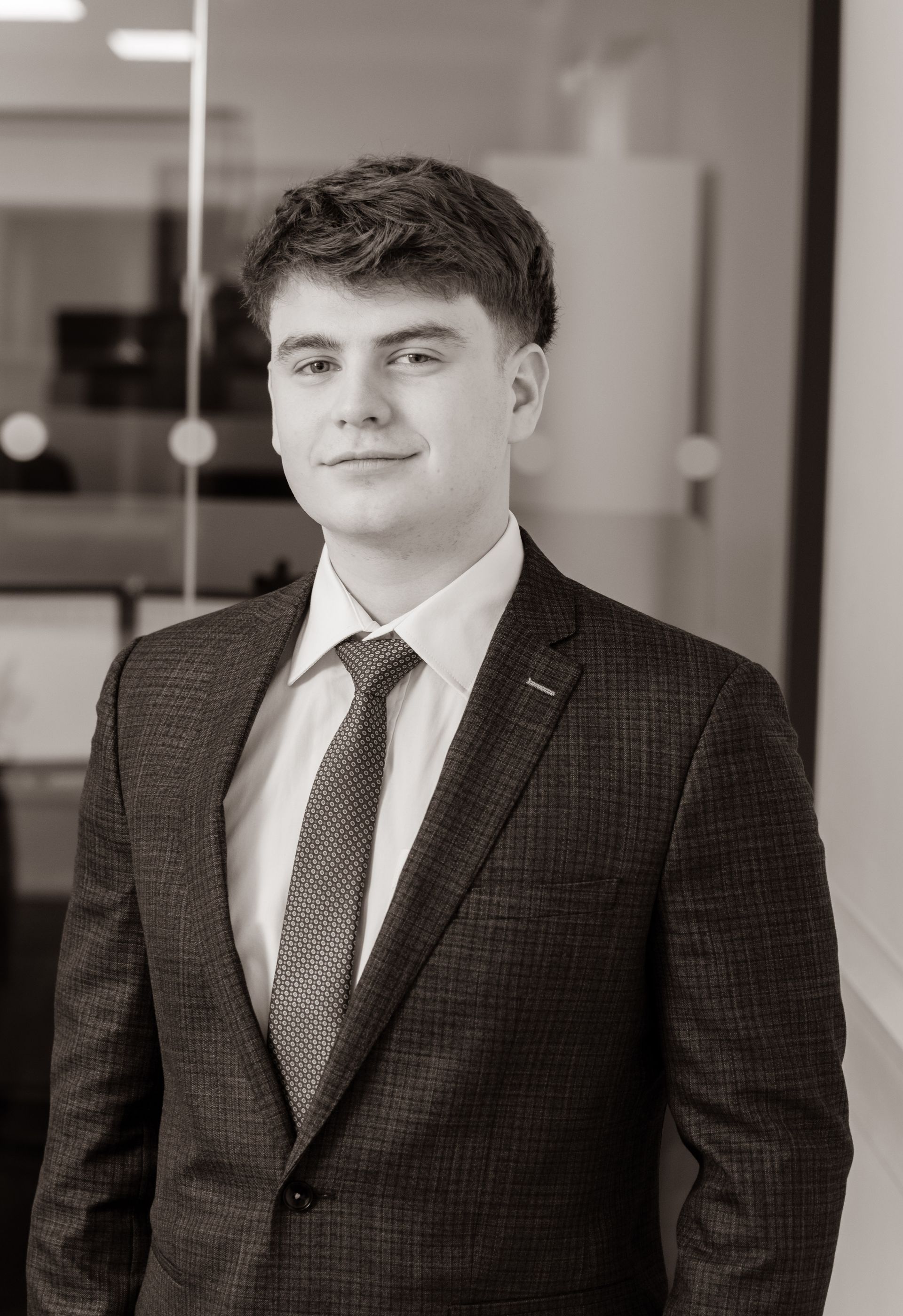 A man with a beard is wearing a suit and tie.