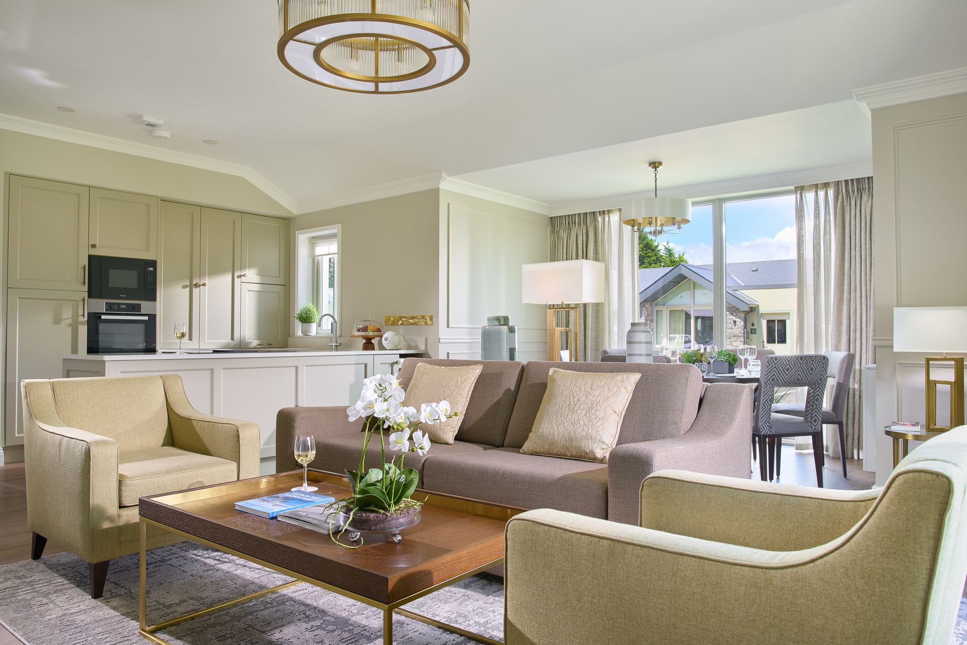 A living room with a couch , chairs , and a coffee table.