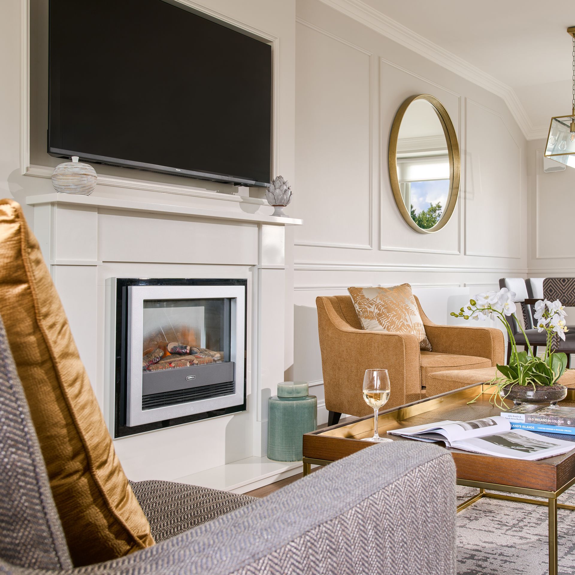 A living room with a fireplace and a flat screen tv