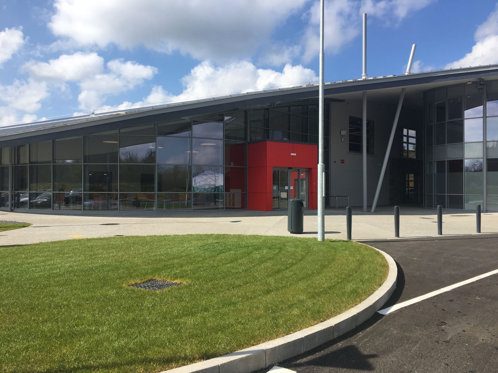 A large building with a lot of windows and a red door.