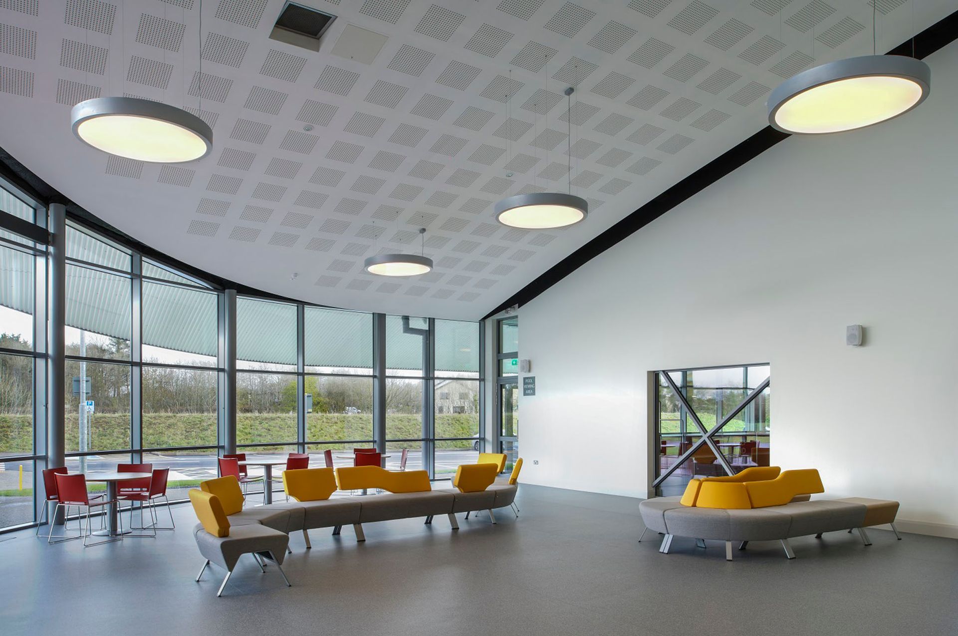 A large room with a lot of windows and furniture