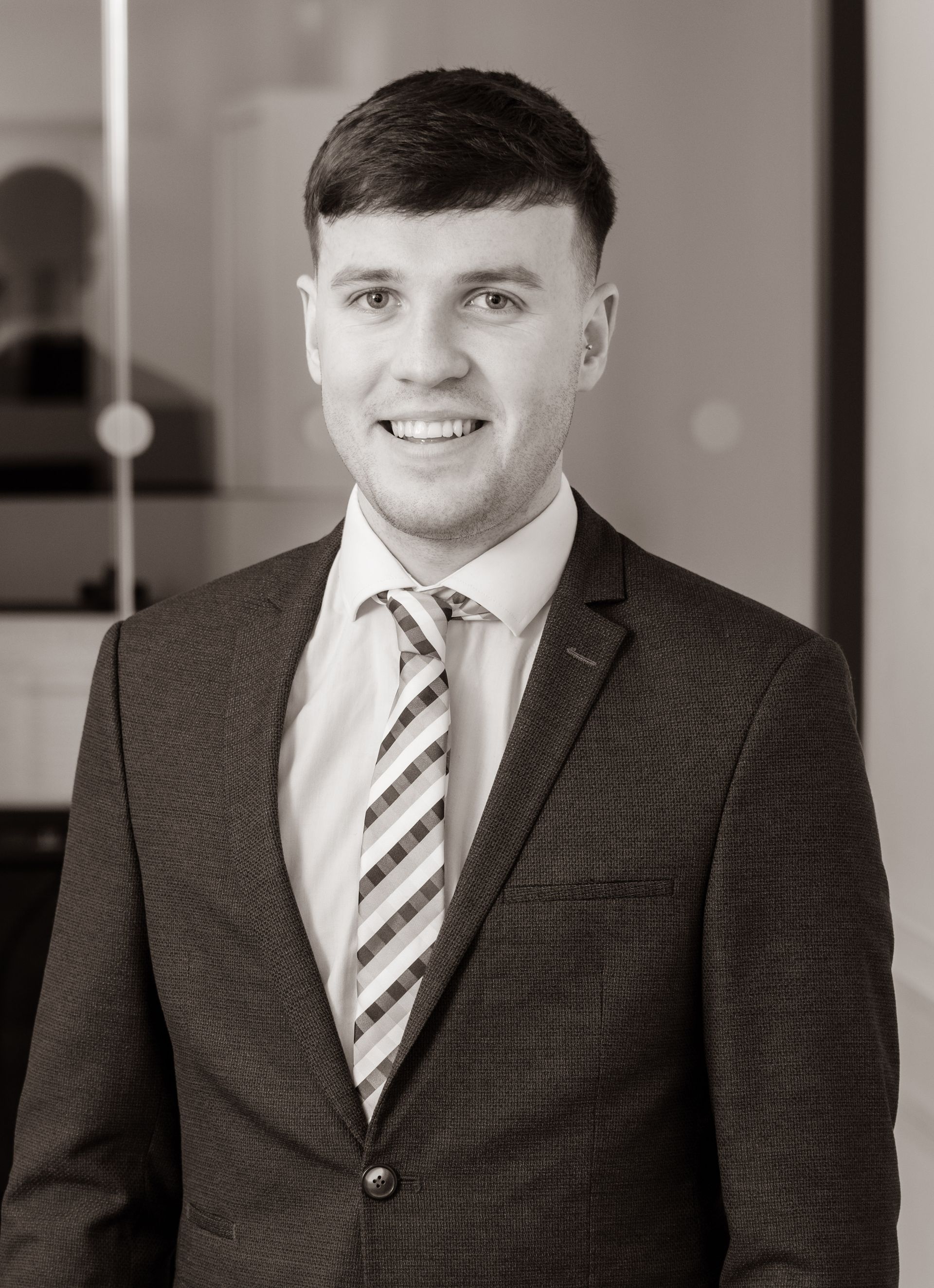 A man with a beard is wearing a suit and tie.