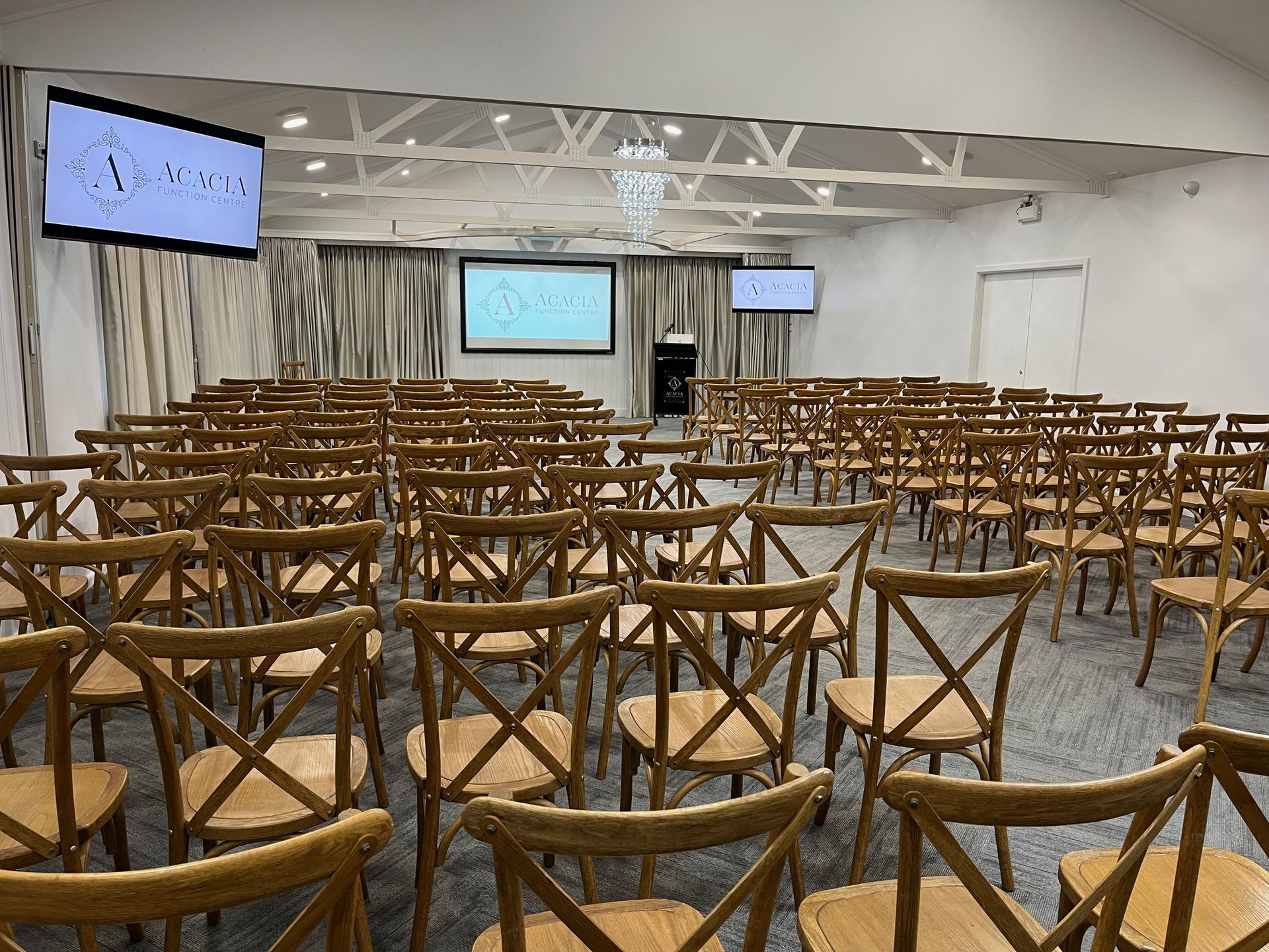 A Large Room Filled with Wooden Chairs and a Projector Screen - Function Venue in Hillvue, NSW