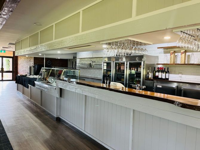 A Long Bar in a Restaurant with a Lot of Wine Glasses on it - Function Venue in Hillvue, NSW