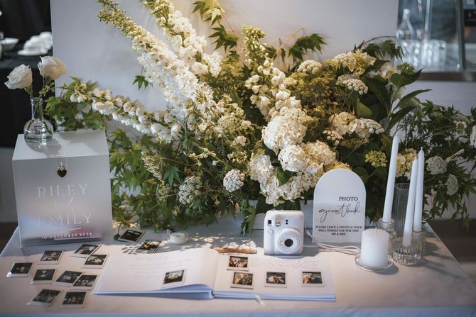 A Table with Flowers, Candles, a Book and a Camera on it - Function Venue in Hillvue, NSW