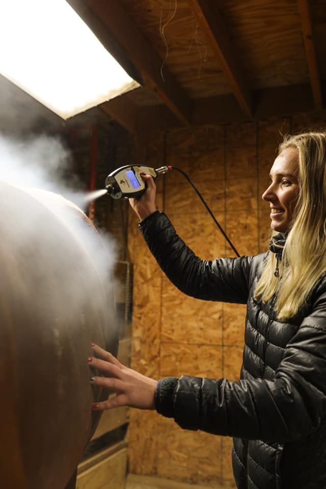 A woman is getting a cryotherapy treatment on her wrist.
