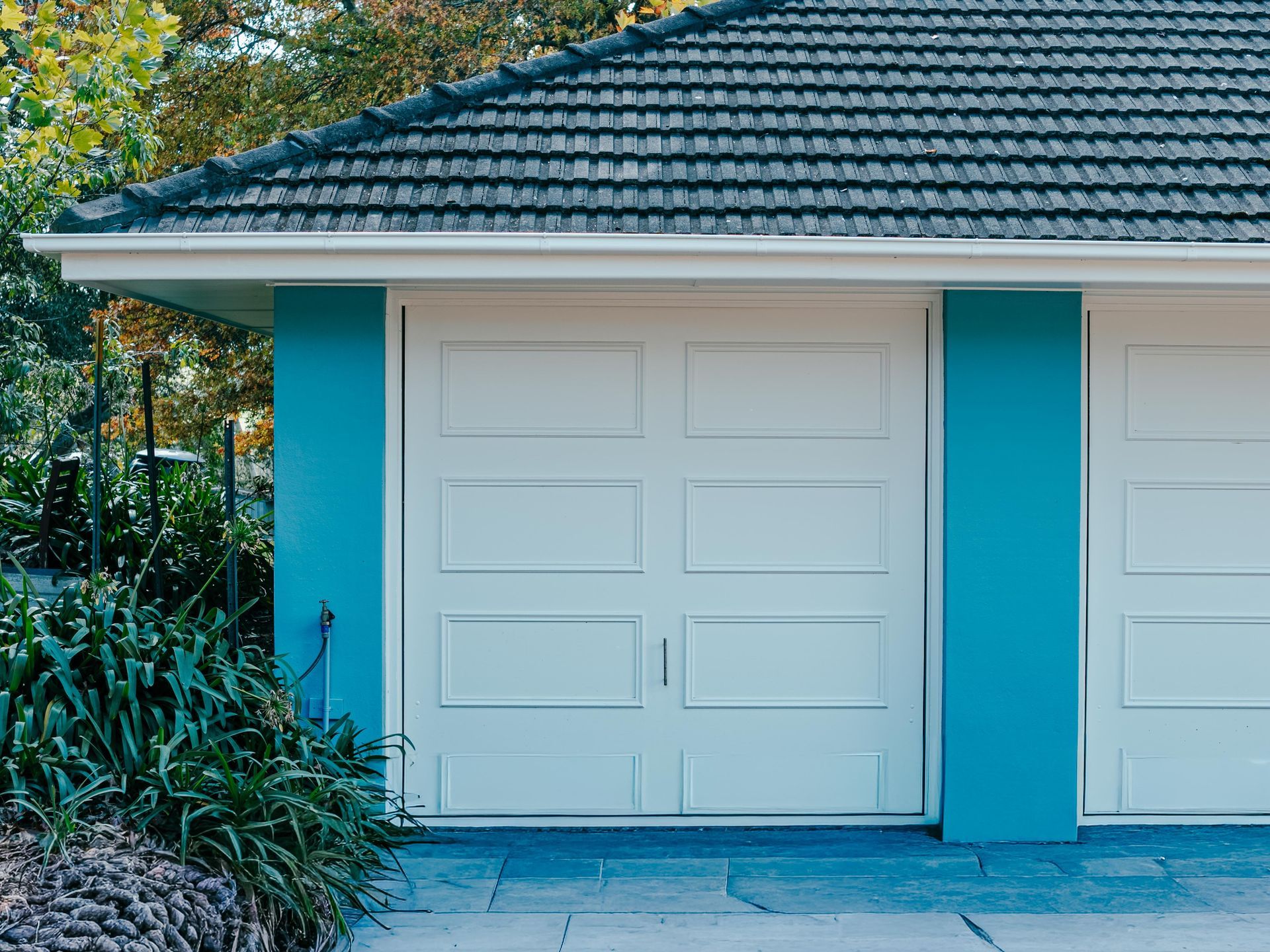 White Garage Door on a Turquoise House — Mittagong Painting in Welby, NSW