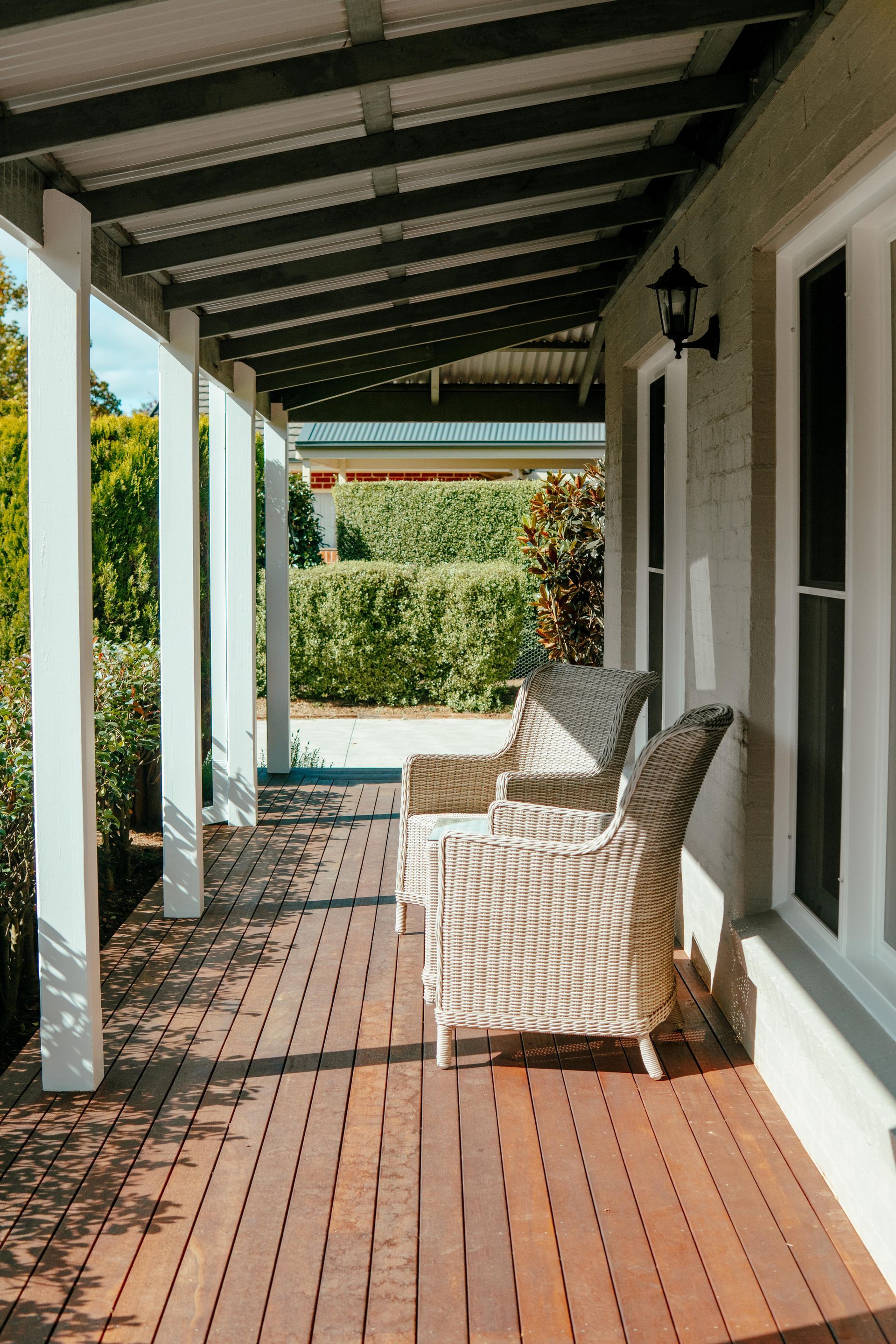 Covered Front Porch With White Chairs — Mittagong Painting in Welby, NSW