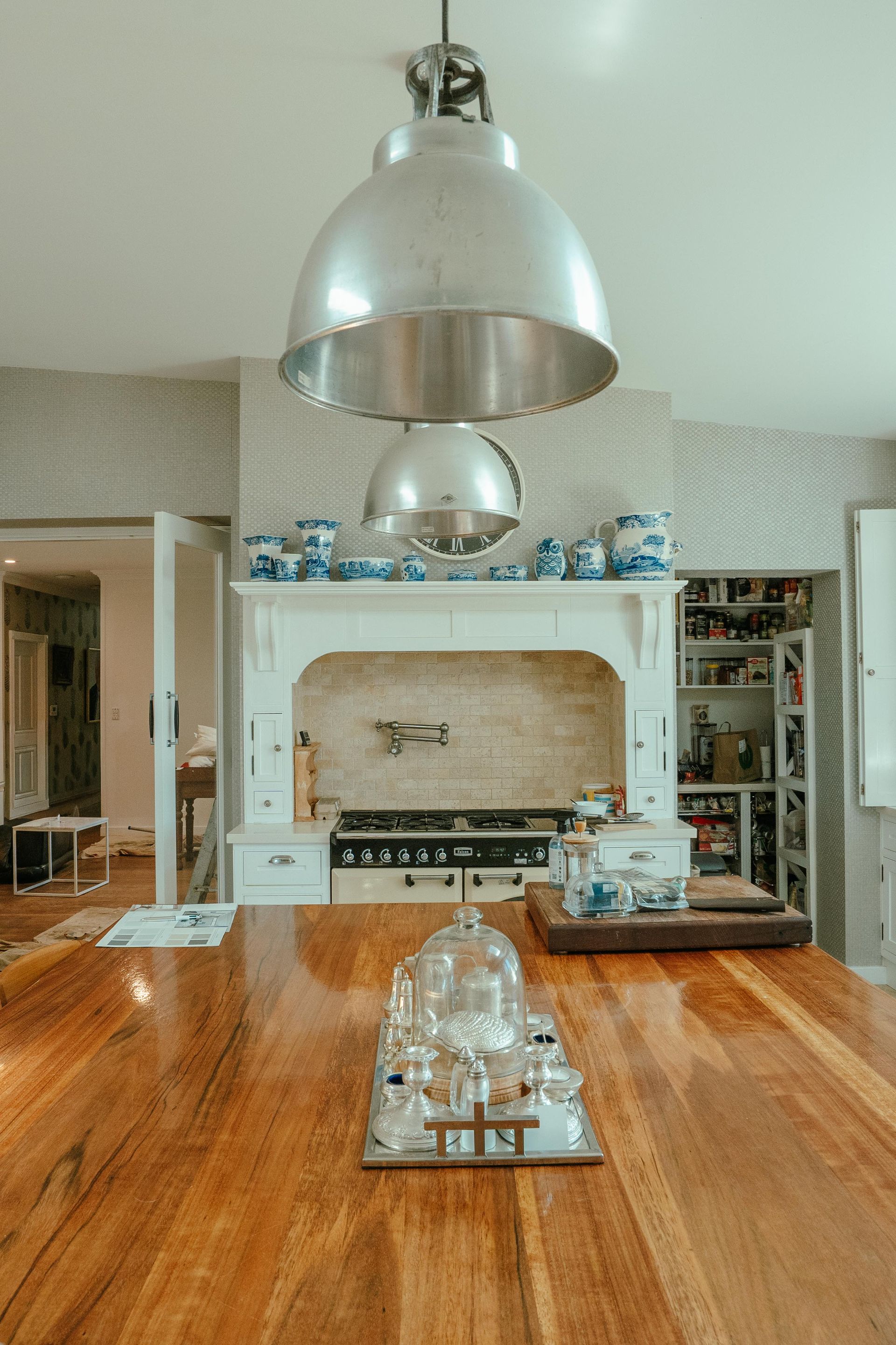 A Kitchen With a Large Wooden Island, Stove, and a Stainless Steel Pendant Light — Mittagong Painting in Mittagong, NSW