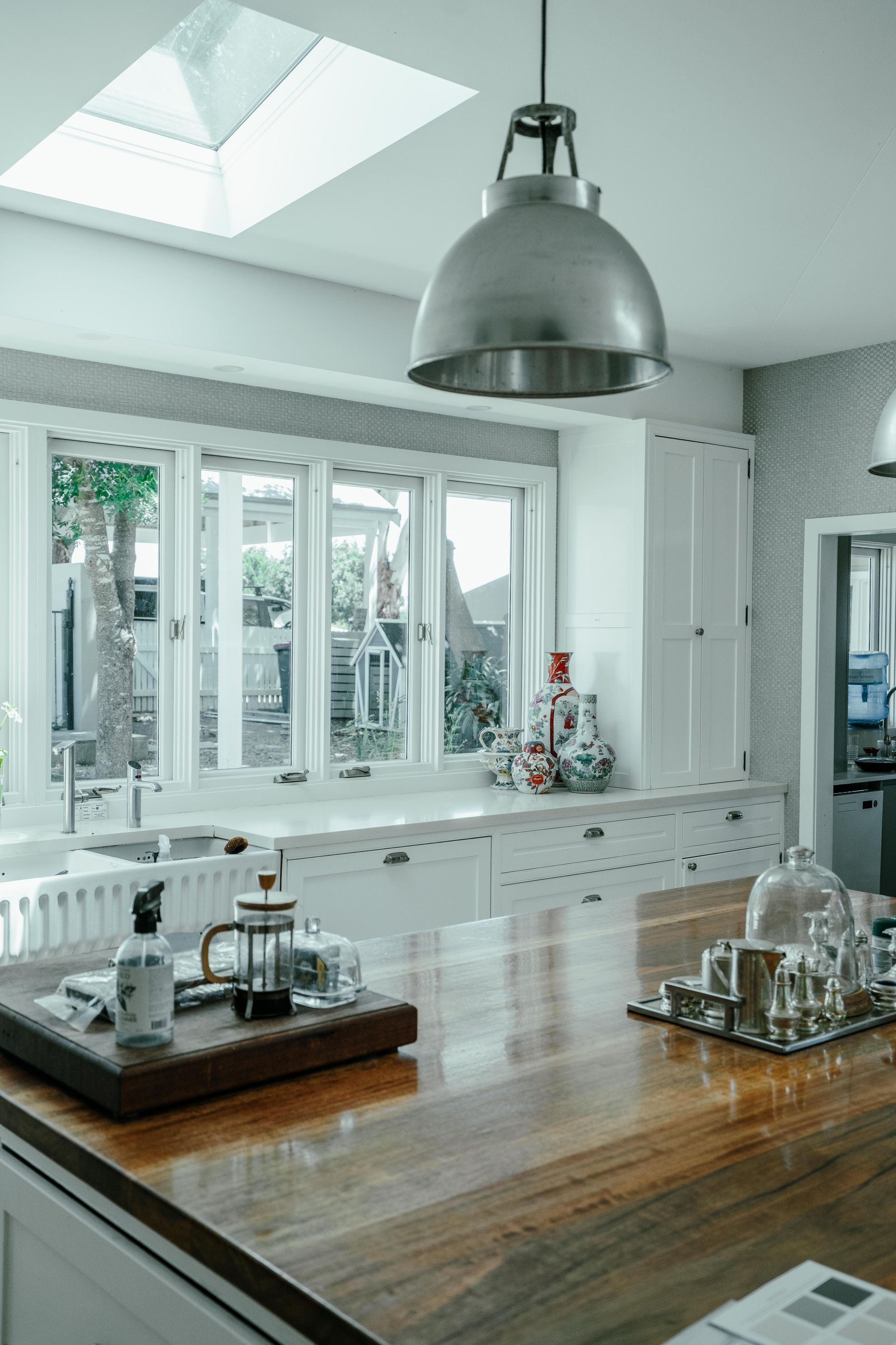Kitchen with skylight, windows, and stainless steel pendant lamp — Mittagong Painting in Bowral, NSW