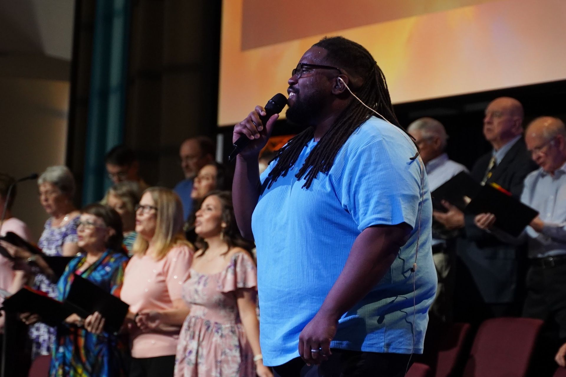 Worship leader singing with the choir